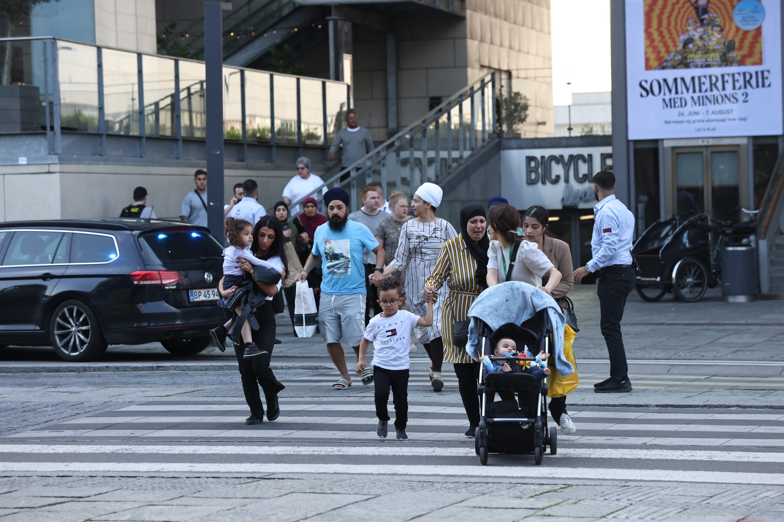 epa10050022 People flee the Fields shopping center during evacuation by armed police, in Oerstad, Copenhagen, Denmark, 03 July 2022. Danish Police has confirmed that shots were fired inside and that several people are injured.  EPA/Olafur Steinar Gestsson  DENMARK OUT