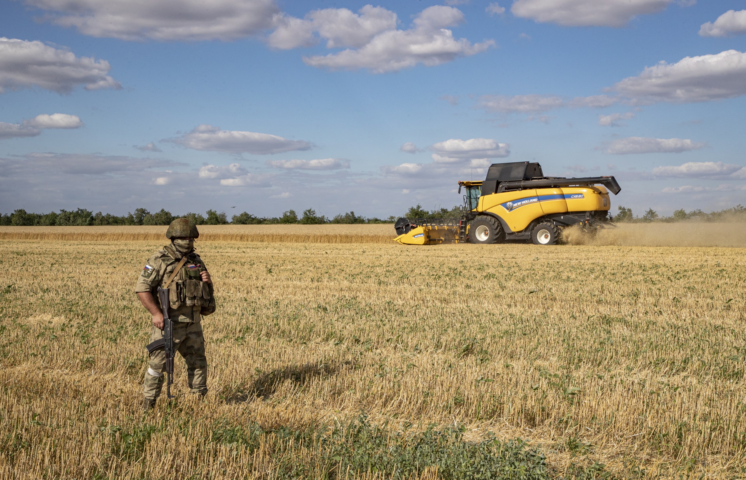 epa10072090 A picture taken during a visit to Melitopol organized by the Russian military shows a Russian serviceman standing guard in a field near Melitopol, Zaporizhia region, southeastern Ukraine, 14 July 2022. (issued 15 July 2022). The conflict in Ukraine has affected the availability and price of wheat worldwide. Melitopol is under the control of Russian forces and the city is administered by a military-civilian administration. On 24 February 2022 Russian troops entered the Ukrainian territory in what the Russian president declared a 'Special Military Operation', starting an armed conflict that has provoked destruction and a humanitarian crisis.  EPA/SERGEI ILNITSKY
