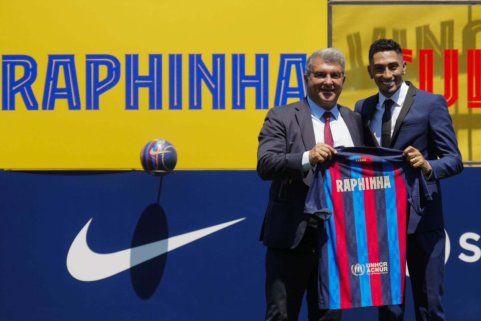 epa10072497 Brazilian striker Raphinha (R) poses with FC Barcelona's presidente Joan Laporta (L) during his presentation as new player of the team during an act held at Sant Joan Despi Sport City in Barcelona, Catalonia, Spain on 15 July 2022.  EPA/Enric Fontcuberta
