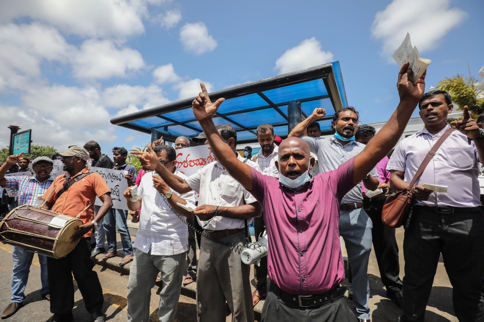 epa10077407 Trade union members shout slogans during a protest against the acting president Ranil Wickremesinghe, in Colombo, Sri Lanka, 18 July 2022.  The trade unions say acting president Ranil Wickremesinghe 'has no proper mandate to run for the new presidency'. The Sri Lankan parliament will run to a fresh vote to elect the new president on 20 July after accepting the resignation of President Gotabaya Rajapaksa after he fled to Singapore through the Maldives following months of anti-government protests fueled by the ongoing economic crisis.  Protests have been rocking the country for over four months as Sri Lanka faces its worst-ever economic crisis in decades due to the lack of foreign reserves, resulting in severe shortages in food, fuel, medicine, and imported goods.  EPA/CHAMILA KARUNARATHNE
