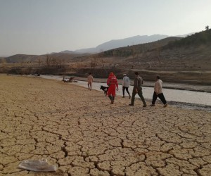epa10087486 A handout photo made available by the Iranian Red Crescent Society (IRCS) on 23 July 2022 shows rescue workers searching near a river bank after flooding in Estehban county, Fars province, southern Iran. According to the Iranian Red Crescent Society quoting local officials, at least 21 people have been killed with two still missing following the massive flood in Estahban. The Red Crescent said it has deployed in the affected regions one relief helicopter, 30 teams, sniffer dogs and 24 operational vehicles.  EPA/IRANIAN RED CRESCENT HANDOUT -- MANDATORY CREDIT -- BEST QUALITY AVAILABLE -- HANDOUT EDITORIAL USE ONLY/NO SALES