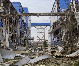 epa10101564 A man walks past a damaged factory building after a rocket hit in the small city of Merefa in the Kharkiv area, Ukraine, 01 August 2022. Kharkiv and surrounding areas have been the target of heavy shelling since February 2022, when Russian troops entered Ukraine starting a conflict that has provoked destruction and a humanitarian crisis.  EPA/SERGEY KOZLOV