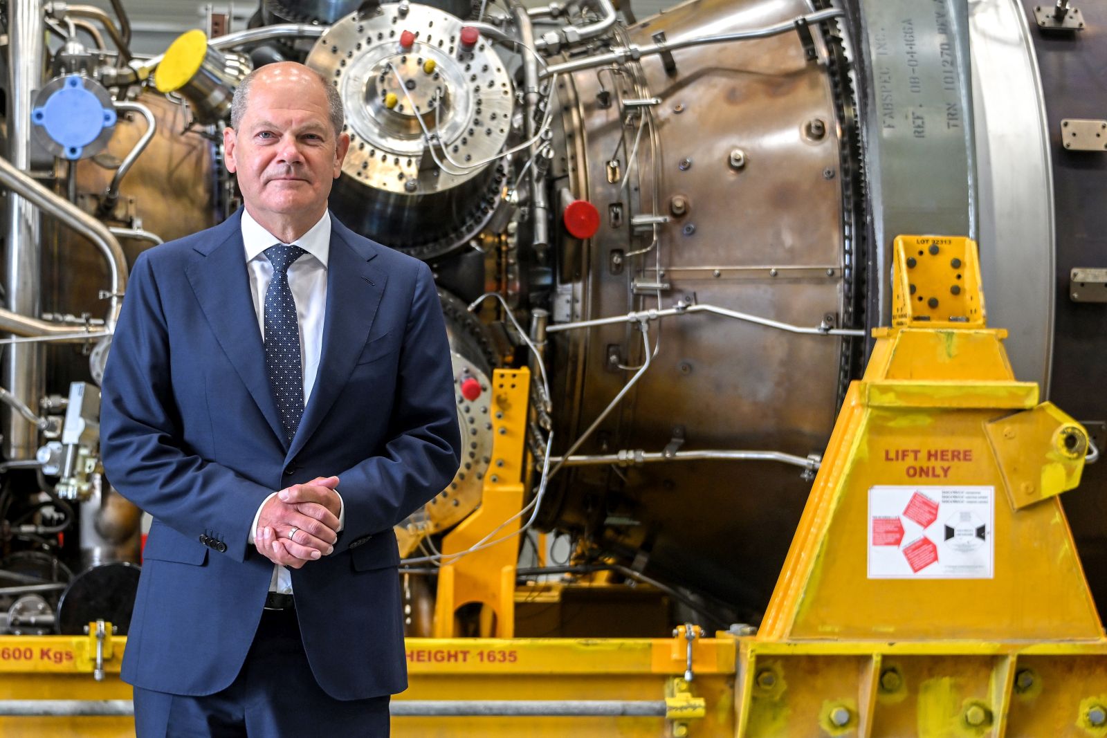 epa10103667 German Chancellor Olaf Scholz arrives to view the turbine serviced in Canada for the Nord Stream 1 natural gas pipeline at the Siemens Energy site in Muelheim an der Ruhr, Germany, 03 August 2022. Russia had already sharply curtailed gas deliveries through the Nord Stream 1 pipeline in mid-June, citing the defective turbine, and has now cut it down to 20 percent of capacity. Representatives of the Russian side had cited problems with the import of the turbine, such as missing customs documents. The German government called this a pretext by the Russian side for not fulfilling the supply contracts.  EPA/SASCHA STEINBACH