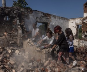 epa10105235 Young volunteers from the 'Repair Together' initiative together with the local residents clean rubble from a house that was destroyed during the Russian invasion, at Ivanivka village, Chernihiv region, Ukraine, 30 July 2022 (issued 04 August 2022). Ivanivka village was under Russian occupation months ago and suffered heavy damage. The volunteer initiative 'Repair Together' is made up mostly of young Ukrainians living in Kyiv and other parts of the country and some foreigners. The group of young people, most of whom before the Russian invasion were into Ukraine's nightlife party culture, in the past months has been cleaning and repairing war-damaged buildings in the Chernihiv region, helping to restore Ukrainian communities which were under Russian occupation. Calling their gatherings 'Toloka' and relying on people's donations and their own funds, the initiative that once started as a small group now gathers around 200 people on weekends. Chernihiv region was one of the most affected regions in Ukraine, becoming a battlefield with many people killed and buildings destroyed, and was partly under the Russian occupation from the beginning of the Russian invasion until early April. Russian troops on 24 February 2022 entered Ukrainian territory, starting a conflict that provoked destruction and a humanitarian crisis.  EPA/ROMAN PILIPEY  ATTENTION: This Image is part of a PHOTO SET