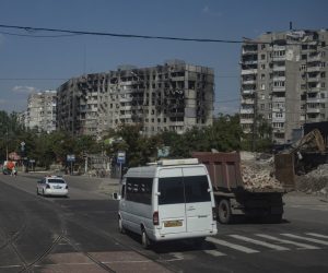 epa10114359 A picture taken during a visit to Mariupol organised by the Russian military shows traffic in a damaged residential district in Mariupol, Donetsk region, Ukraine, 10 August 2022. Twelve five-storey houses with 1,011 apartments are being built. This number of apartments will accommodate more than 2,500 people. About 1,000 people work at the construction site, more than 150 pieces of equipment are involved, according to Oleg Pechenkin, project manager of the military construction complex of the Russian Defense Ministry, as construction and restoration of residential districts, hospitals and engineering networks began in Mariupol. The first building will be completed by September 2022.  EPA/SERGEI ILNITSKY