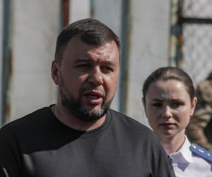 epa10115067 A picture taken during a visit to Yelenovka organised by the Russian military shows Head of the self-proclaimed Donetsk People's Republic Denis Pushilin (L) speaking with journalists outside of the destroyed barrack where Ukrainian prisoners of war were held in a Yelenovka detention center in Yelenovka, Donetsk region, Ukraine, 10 August 2022. As a result of a rocket attack on a pre-trial detention center near Yelenovka on July 29, 51 Ukrainian prisoners of war were killed and 193 were wounded. ‘The investigation qualified the strike of the Armed Forces of Ukraine on the pre-trial detention center in Yelenovka as a terrorist act’, Vitalia Chernyavskaya, the official representative of the DPR Prosecutor General's Office, told reporters. The official representative of the Russian Ministry of Defense, Lieutenant-General Igor Konashenkov, reported that on July 29, the Armed Forces of Ukraine attacked a pre-trial detention center near Yelenovka from the American HIMARS multiple launch rocket system. Later, the Ministry of Defense stated that Russia, in the interests of conducting an objective investigation of the attack on the pre-trial detention center, officially invited experts from the UN and the International Committee of the Red Cross.  EPA/SERGEI ILNITSKY