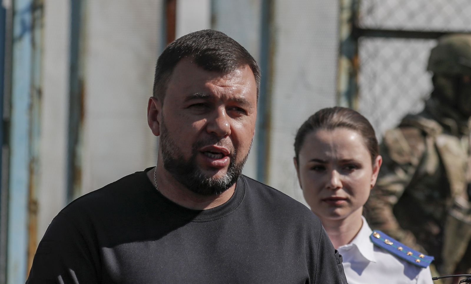 epa10115067 A picture taken during a visit to Yelenovka organised by the Russian military shows Head of the self-proclaimed Donetsk People's Republic Denis Pushilin (L) speaking with journalists outside of the destroyed barrack where Ukrainian prisoners of war were held in a Yelenovka detention center in Yelenovka, Donetsk region, Ukraine, 10 August 2022. As a result of a rocket attack on a pre-trial detention center near Yelenovka on July 29, 51 Ukrainian prisoners of war were killed and 193 were wounded. ‘The investigation qualified the strike of the Armed Forces of Ukraine on the pre-trial detention center in Yelenovka as a terrorist act’, Vitalia Chernyavskaya, the official representative of the DPR Prosecutor General's Office, told reporters. The official representative of the Russian Ministry of Defense, Lieutenant-General Igor Konashenkov, reported that on July 29, the Armed Forces of Ukraine attacked a pre-trial detention center near Yelenovka from the American HIMARS multiple launch rocket system. Later, the Ministry of Defense stated that Russia, in the interests of conducting an objective investigation of the attack on the pre-trial detention center, officially invited experts from the UN and the International Committee of the Red Cross.  EPA/SERGEI ILNITSKY
