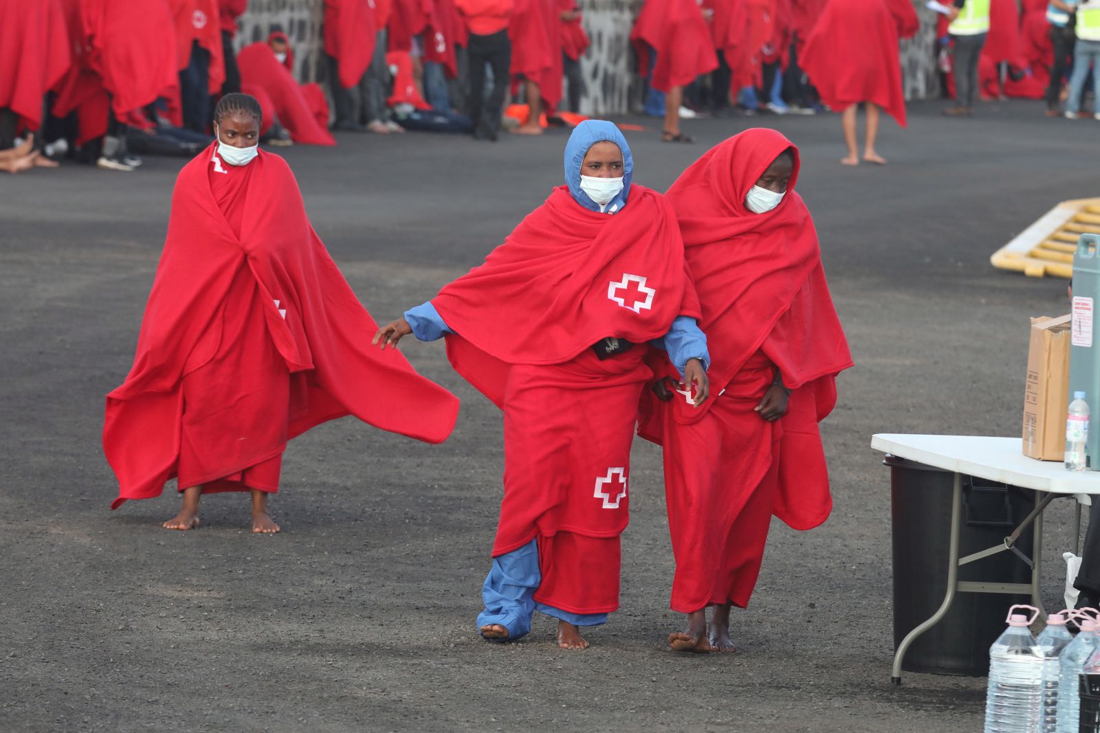 epa10116944 Migrants arrive in the port in Arrecife, Lanzarote island, Canary Islands, Spain, 12 August 2022. Spanish Sea Rescue Unit rescued 317 people in seven boats in a frenetic night of rescues off Lanzarote island.  EPA/ADRIEL PERDOMO