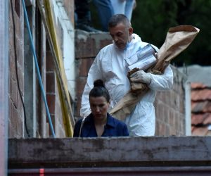 epa10117913 A crime scene investigator carries a rifle as evidence believed to belong to the perpetrator of a mass shooting at Cetinje, Montenegro, 12 August 2022.A 34 year old male in Montenegro went on a shooting rampage after a family dispute, killing at least 10 people on the street before being gunned down in an exchange of fire with the police.  EPA/BORIS PEJOVIC