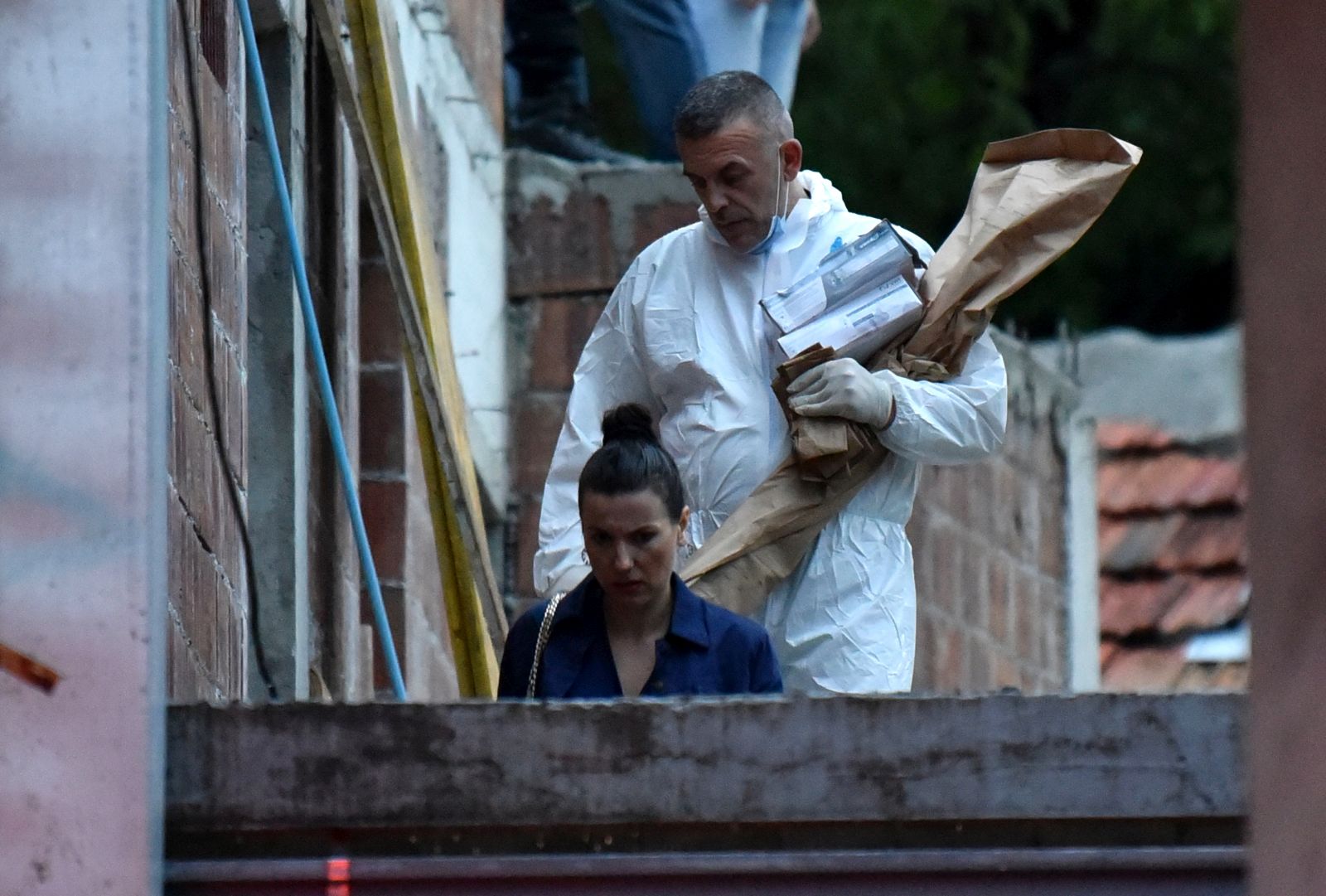 epa10117913 A crime scene investigator carries a rifle as evidence believed to belong to the perpetrator of a mass shooting at Cetinje, Montenegro, 12 August 2022.A 34 year old male in Montenegro went on a shooting rampage after a family dispute, killing at least 10 people on the street before being gunned down in an exchange of fire with the police.  EPA/BORIS PEJOVIC