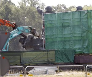 epa10134895 Track-mounted excavators destroy the statue of three Red Army soldiers at the Monument of Liberators of Soviet Latvia and Riga from the German Fascist Invaders (unofficially known simply as the Victory Monument) in Riga Victory Park, Latvia, 23 August 2022. Parts of R´ga's Soviet monument have been demolished on 23 August after the Latvian Parliament voted to pave the way for the demolition of the monument in Riga in May 2022.  EPA/TOMS KALNINS
