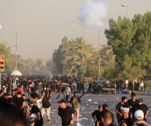 epa10145846 Supporters of Iraqi Shiite cleric Muqtada al-Sadr, head of the Sadrist movement, clash with anti-riot forces near the office of prime minister, Baghdad, Iraq, 29 August 2022. The leader of the Sadrist movement Muqtada al-Sadr announced on 29 August his final retirement and the closure of institutions, prompting supporters, who had been on a sit-in at the Iraqi parliament since July, to storm the Republican Palace, that houses the office of the prime minister, while a curfew was announced in Baghdad from 3:30pm (12:30 GMT).  EPA/AHMED JALIL
