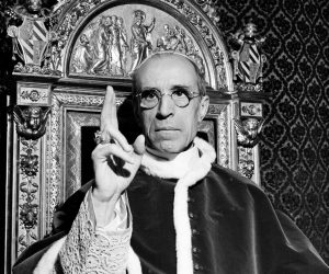 FILE - In this file photo dated Sept. 1945, Pope Pius XII, wearing the ring of St. Peter, raises his right hand in a papal blessing at the Vatican. The Vatican’s chief librarian and archivists said Thursday, Feb. 20, 2020 that all researchers _ regardless of nationality, faith and ideology _ were welcome to request access to the soon-to-open Vatican’s apostolic library on Pope Pius XII starting March 2.  (AP Photo, File)