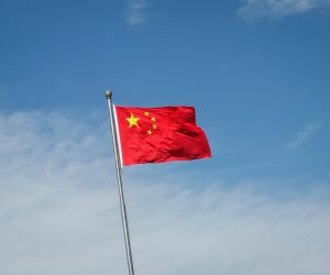 epa10133364 China's flag flutters along a road in Beijing, China, 22 August 2022. China has cut its benchmark loan rates to help revive its economy. China's one year loan prime rate was cut from 3.7 percent to 3.65 percent, while the loan rates for mortgages were cut from 4.45 percent to 4.3 percent, the People's Bank of China (PBOC) said.  EPA/MARK R. CRISTINO