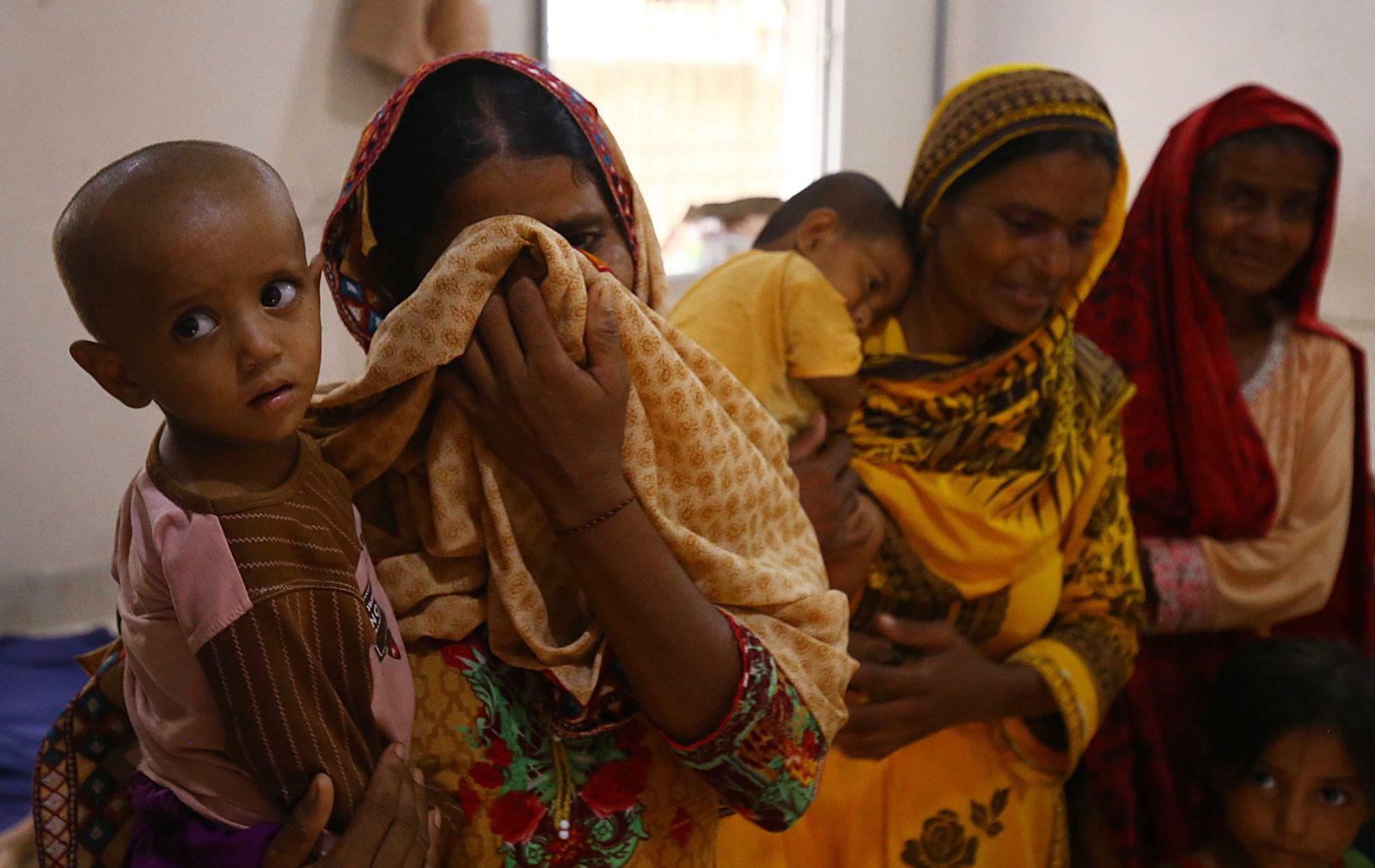 epa10138975 People affected by monsoon rains and floods take shelter in a government's school building after they were displaced from different flood-hit areas of the Sindh province, in Karachi, Pakistan, 25 August 2022.. Flash floods caused by heavy monsoon rains have killed 830 people, including 313 children, across Pakistan in the last two months, according to the National Disaster Management Authority (NDMA). More than three million people have been affected by the floods, with over 161,000 still living in relief camps since the monsoon began on June 14, government data showed.  EPA/SHAHZAIB AKBER