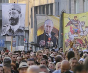 epa10144053 Protestors march holding flags of controversial Serb World War II leader General Dragoljub Draza Mihailovic (L), and Russian President Vladimir Putin (C), during a protest against the international LGBTQ event EuroPride in Belgrade, Serbia, 28 August 2022. EuroPride, a pan-European international event dedicated to LGBTQ pride, is hosted by a different European city each year and is scheduled to be held in Belgrade from 12-18 September 2022. According to country leaders Belgrade will not host the event, citing threats from right-wing extremist groups and fears of clashes.  EPA/ANDREJ CUKIC