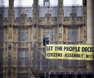 epa10154721 An environmental activist from Extinction Rebellion group glue himself to a scaffolding of the Palace of Westminster, home to the Houses of Parliament as they demand a 'citizens' assembly' to combat climate change, in London, Britain, 02 September 2022. According to Extinction Rebellion, the group of about 50 people were involved in the 'non-violent' action at the Palace of Westminster including three protesters superglued in front of the Speaker's seat.  EPA/TOLGA AKMEN