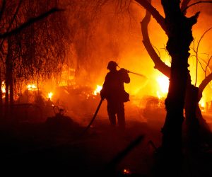 epa10163280 Fire fighters try to put out the Fairview Fire as it burns a home on Gibbel Road in Hemet, California, USA, 05 September 2022 (issued 06 September 2022). The fire expanded to over 2,000 acres, destroying multiple structures and claiming two lives.  EPA/Allison Dinner