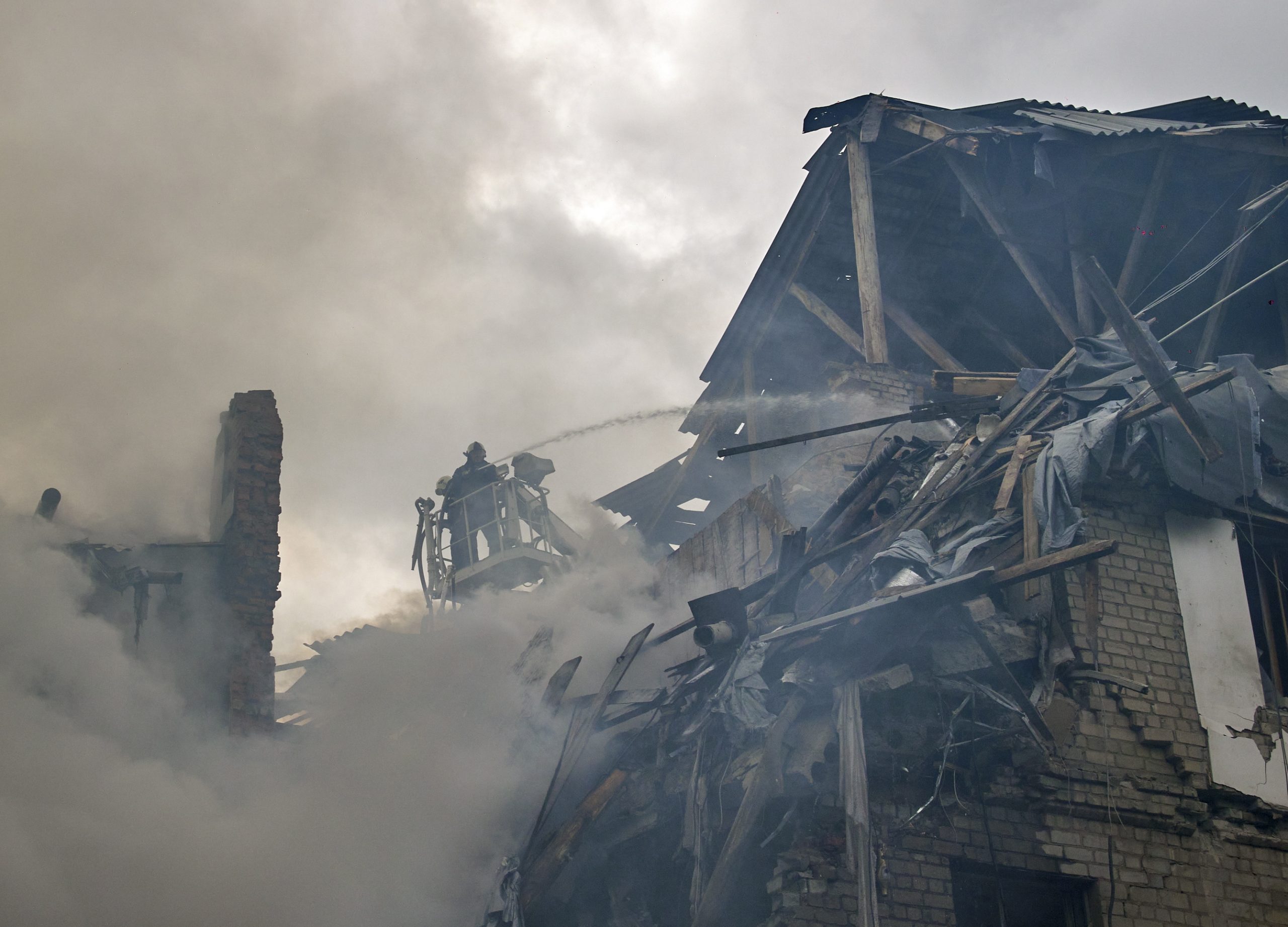 epa10164406 Ukrainian rescuers work on the site after airstrikes destroyed a residential building in Kharkiv, Ukraine, 06 September 2022. Kharkiv and surrounding areas have been the target of heavy shelling since February 2022, when Russian troops entered Ukraine starting a conflict that has provoked destruction and a humanitarian crisis.  EPA/SERGEY KOZLOV