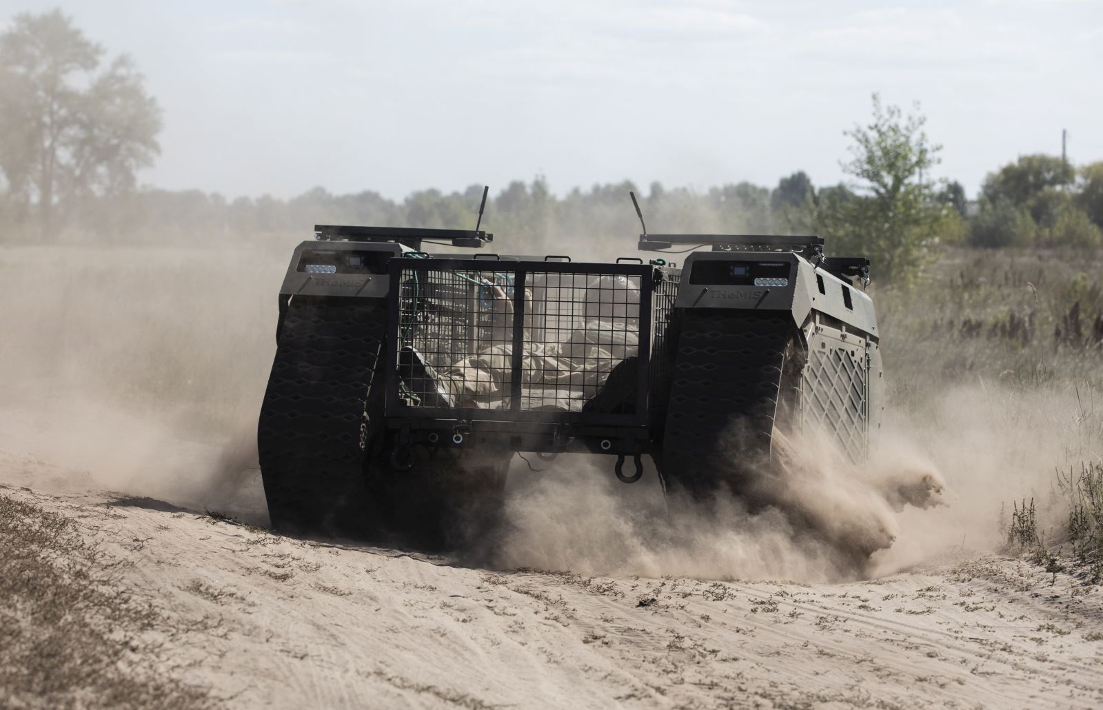 epa10170666 Servicemen of the Ukrainian medical battalion 'Hospitallers' hold field tests of THeMIS multi-purpose crawler drone of the Estonian company Milrem Robotics which will be used for evacuation of wounded soldiers on the frontline zone, on a shooting range close to Kyiv, Ukraine, 08 September 2022 amid the Russian invasion. Russian troops entered Ukraine on 24 February 2022 starting a conflict that has provoked destruction and a humanitarian crisis.  EPA/MIKHAIL PALINCHAK