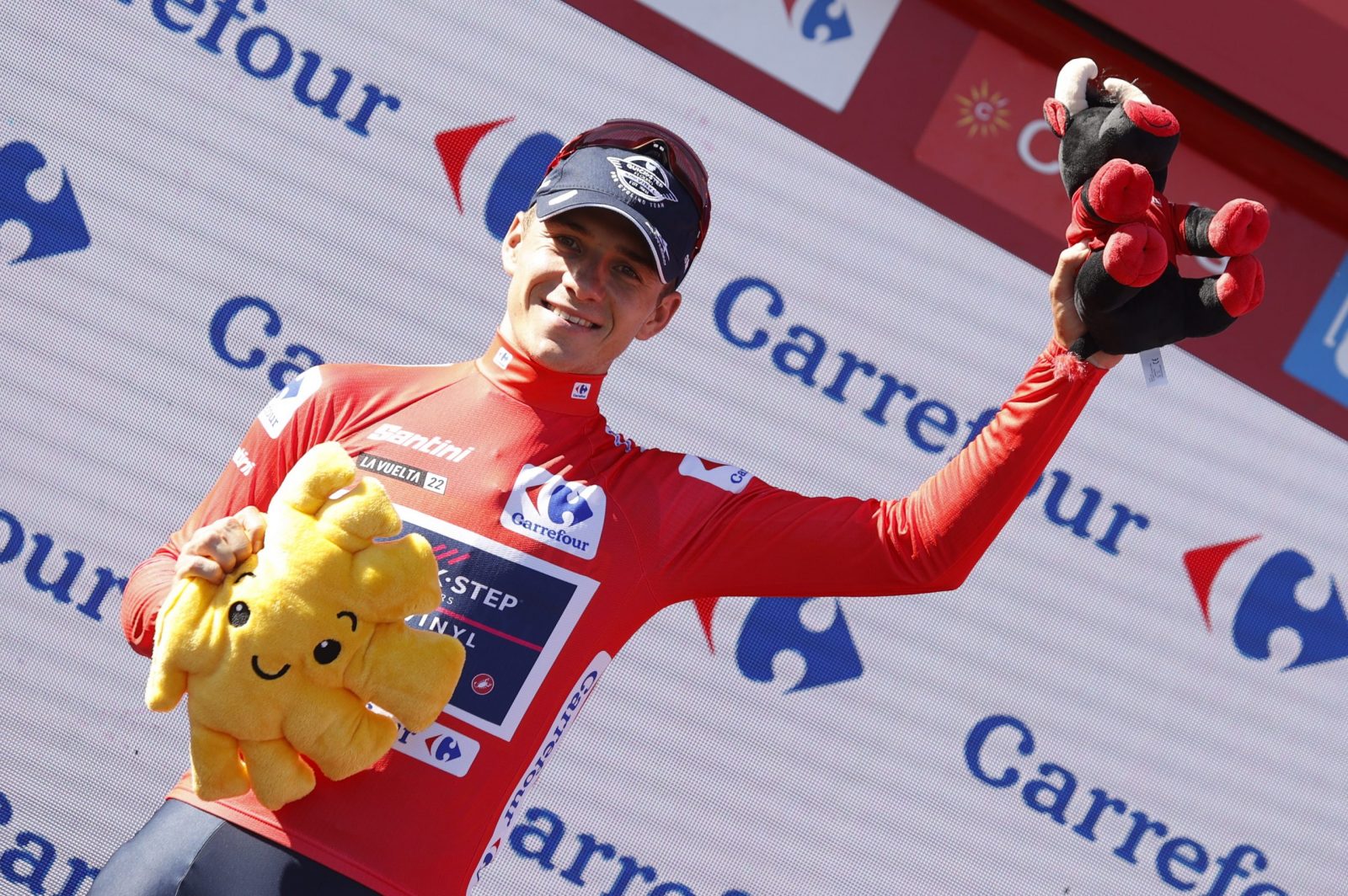 epa10173929 Belgian rider Remco Evenepoel of the Quick-Step Alpha Vinyl Team celebrates on the podium after retaining the overall leader's red jersey following the 19th stage of the Vuelta a Espana cycling tour over 138.3km around Talavera de la Reina, central Spain, 09 September 2022.  EPA/Javier Lizon