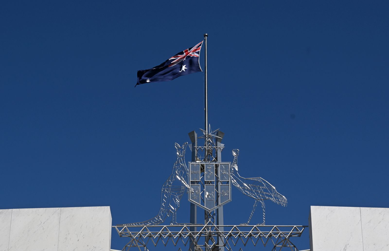 epa10176961 The Australian flag is seen at full mast after the Proclamation of King Charles III, on the forecourt of Parliament House, in Canberra, Australia, 11 September 2022. The monarch's representative in Australia proclaimed the ascension of Britain's King Charles III as mourning continues around the nation for Queen Elizabeth II.  EPA/MICK TSIKAS AUSTRALIA AND NEW ZEALAND OUT