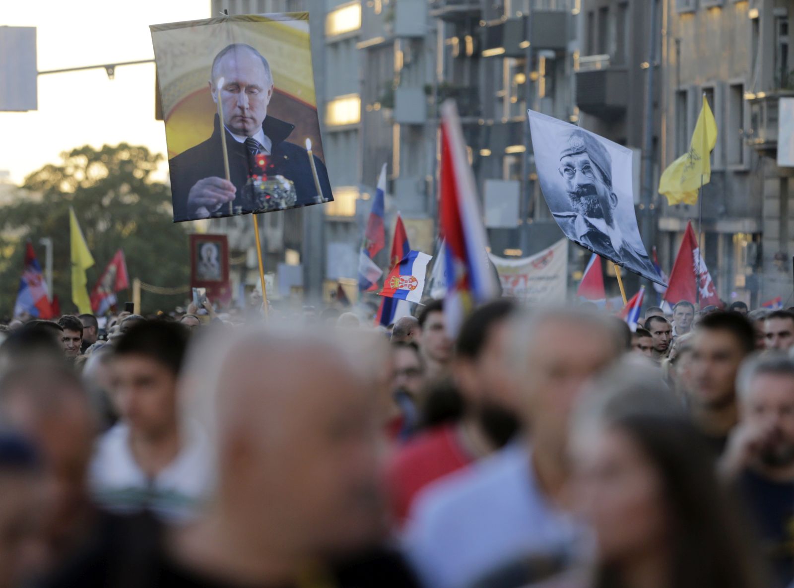 epa10178605 Protestors march holding flags of controversial Serb World War II leader General Dragoljub Draza Mihailovic (R) and Russian President Vladimir Putin (L) during a protest against the international LGBTQ event EuroPride in Belgrade, Serbia, 11 September 2022. EuroPride, a pan-European international event dedicated to LGBTQ pride, is hosted by a different European city each year. Serbia's capital Belgrade is supposed to host the event on the 17 September 2022, but according to country leaders, citing threats from right-wing extremist groups and fears of clashes the final decision on whether the event will be held has not been confirmed.  EPA/ANDREJ CUKIC