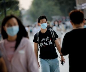 epa10179565 People wearing face masks walk around 798 Art Zone, or Dashanzi Art District, in Beijing, China, 12 September 2022. The National Health Commission suggested people to avoid or reduce intercity travels during the Mid-Autumn Festival holidays, in order to minimize the risk of epidemic transmission, as the country on 11 September reported little over 200 new locally transmitted COVID-19 cases.  EPA/WU HAO