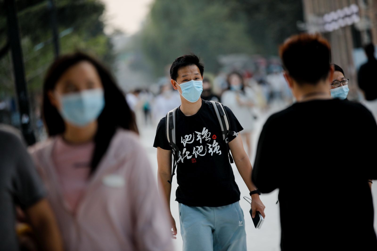 epa10179565 People wearing face masks walk around 798 Art Zone, or Dashanzi Art District, in Beijing, China, 12 September 2022. The National Health Commission suggested people to avoid or reduce intercity travels during the Mid-Autumn Festival holidays, in order to minimize the risk of epidemic transmission, as the country on 11 September reported little over 200 new locally transmitted COVID-19 cases.  EPA/WU HAO