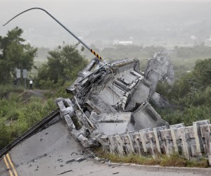 epa10192681 A Taiwanese resident walks past the Gaoliao bridge that collapsed after a magnitude 6.8 earthquake hit Yuli Township; in Hualien County, Taiwan, 19 September 2022. The series of earthquakes and aftershocks on 18 September, caused minor structural damage and derailed a train in eastern Taiwan.  EPA/RITCHIE B. TONGO