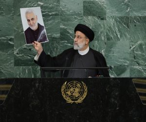 epa10196878 President Seyyed Ebrahim Raisi of Iran holds up a photo of Qasem Soleimani as he delivers his address during the 77th General Debate inside the General Assembly Hall at United Nations Headquarters in New York, New York, USA, 21 September 2022.  EPA/JUSTIN LANE