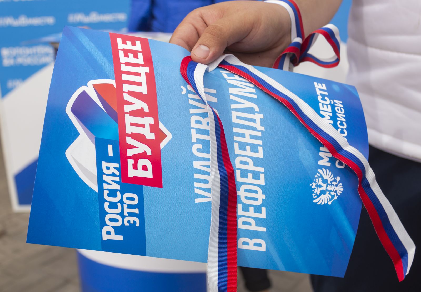 epa10199041 A volunteer distributes campaign booklets reading 'Russia is the future. Attend referendum. We are together with Russia' and straps in the colors of the Russian national flag during a campaign rally for a referendum to join the Russian Federation in downtown Luhansk, Ukraine, 22 September 2022. The parliaments of the self-proclaimed Luhansk and Donetsk Peoples Republics as well as the military-civilian administrations controlled by Russia of the Kherson and Zaporizhzhia regions decided to hold referendums on the future of these territories. On 24 February 2022 Russian troops entered the Ukrainian territory in what the Russian president declared a 'Special Military Operation', starting an armed conflict that has provoked destruction and a humanitarian crisis.  EPA/STRINGER
