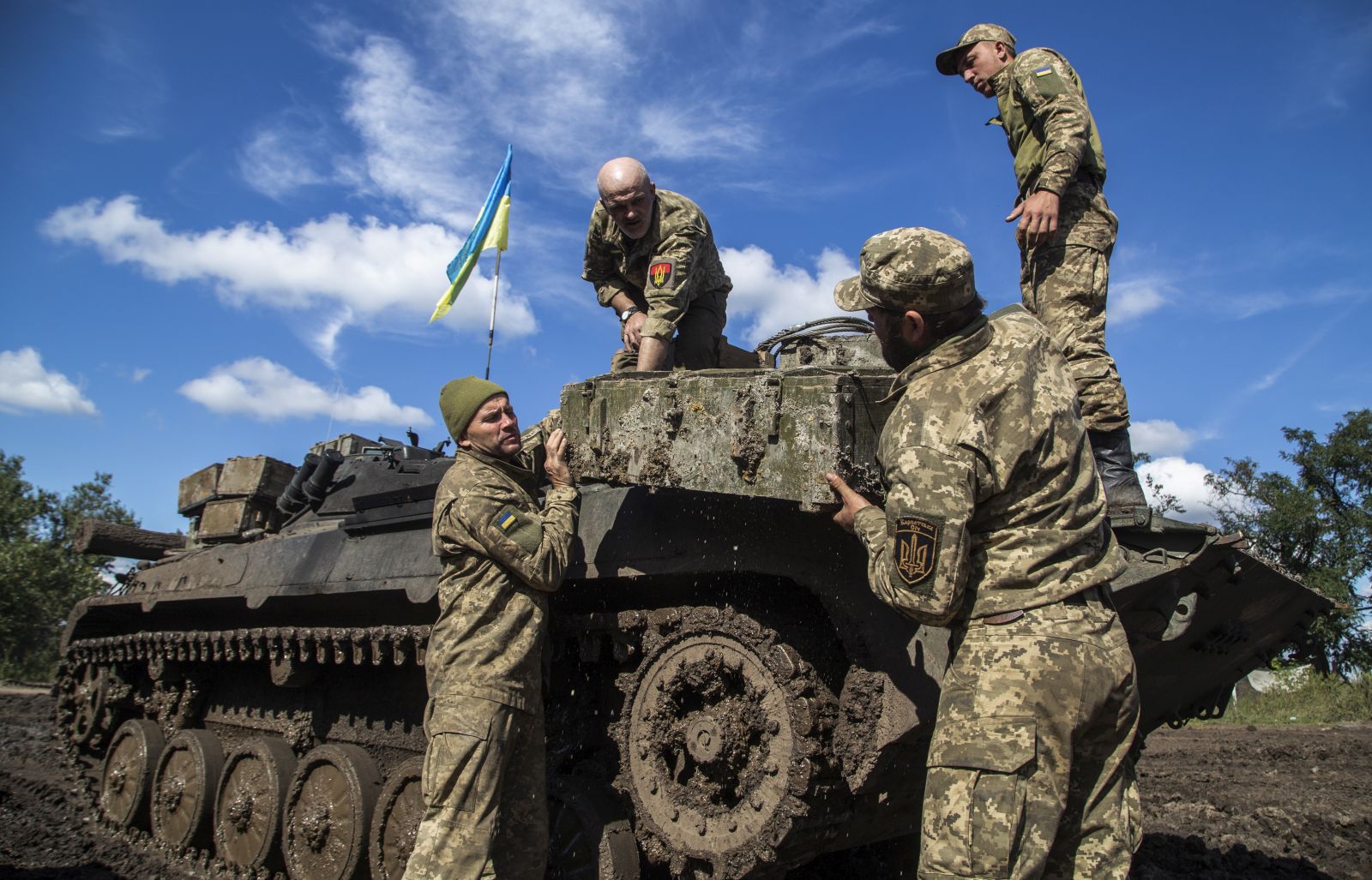 epa10199950 Ukrainian servicemen take an ammunition box from a Russian APC at a former position of Russian troops in the Kharkiv area, Ukraine, 22 September 2022. The Ukrainian army pushed Russian troops from occupied territory in the northeast of the country in a counterattack. Kharkiv and surrounding areas have been the target of heavy shelling since February 2022, when Russian troops entered Ukraine starting a conflict that has provoked destruction and a humanitarian crisis.  EPA/OLEKSANDR RATUSHNIAK