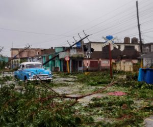 epaselect epa10210512 A car drives through debris on the street after the passage of Hurricane Ian, in Pinar del Rio, Cuba, 27 September 2022. Ian made landfall in western Cuba as a category 3 hurricane, causing considerable material damage with heavy rains and strong winds, before continuing northward toward Florida.  EPA/Yander Zamora