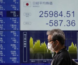 epaselect epa10210923 A passerby walks past a stock market indicator board in Tokyo, Japan, 28 September 2022. Tokyo's 225-issue Nikkei Stock Average closed the morning trading session with a three-month intraday low following overnight loss in New York’s Dow Jones.  EPA/FRANCK ROBICHON