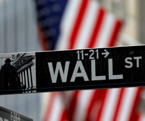 FILE PHOTO: Raindrops hang on a sign for Wall Street outside the New York Stock Exchange in Manhattan in New York City, New York, U.S., October 26, 2020. REUTERS/Mike Segar/File Photo Photo: MIKE SEGAR/REUTERS