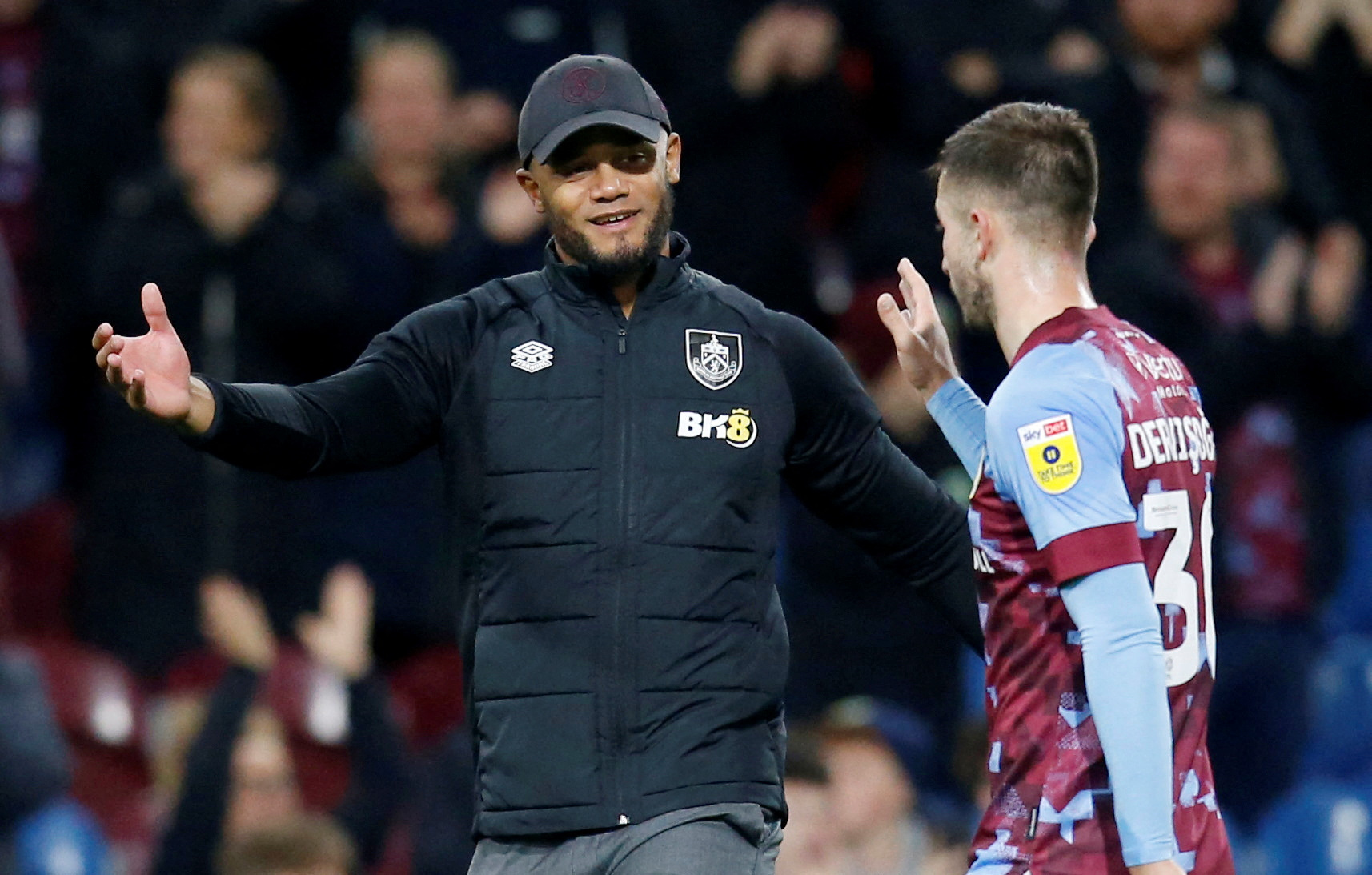 Soccer Football - Championship - Burnley v Norwich City - Turf Moor, Burnley, Britain - October 25, 2022 Burnley manager Vincent Kompany celebrates with Halil Dervisoglu after the match    Action Images/Ed Sykes  EDITORIAL USE ONLY. No use with unauthorized audio, video, data, fixture lists, club/league logos or "live" services. Online in-match use limited to 75 images, no video emulation. No use in betting, games or single club/league/player publications.  Please contact your account representative for further details.