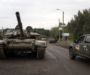 epa10186105 A Ukrainian military vehicle (R) passes by a destroyed Russian tank (L) in the reclaimed city of Izyum, Ukraine, 15 September 2022. The Ukrainian army pushed Russian troops from occupied territory in the northeast of the country in a counterattack. Kharkiv and surrounding areas have been the target of heavy shelling since February 2022, when Russian troops entered Ukraine starting a conflict that has provoked destruction and a humanitarian crisis.  EPA/ANASTASIA VLASOVA