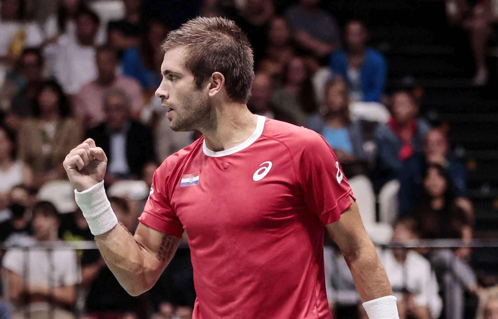 epa10186454 Borna Coric of Croatia celebrates after defeating Mikael Ymer of Sweden during the Davis Cup Finals group A tie between Croatia and Sweden in Casalecchio, near Bologna, Italy, 15 September 2022.  EPA/ELISABETTA BARACCHI