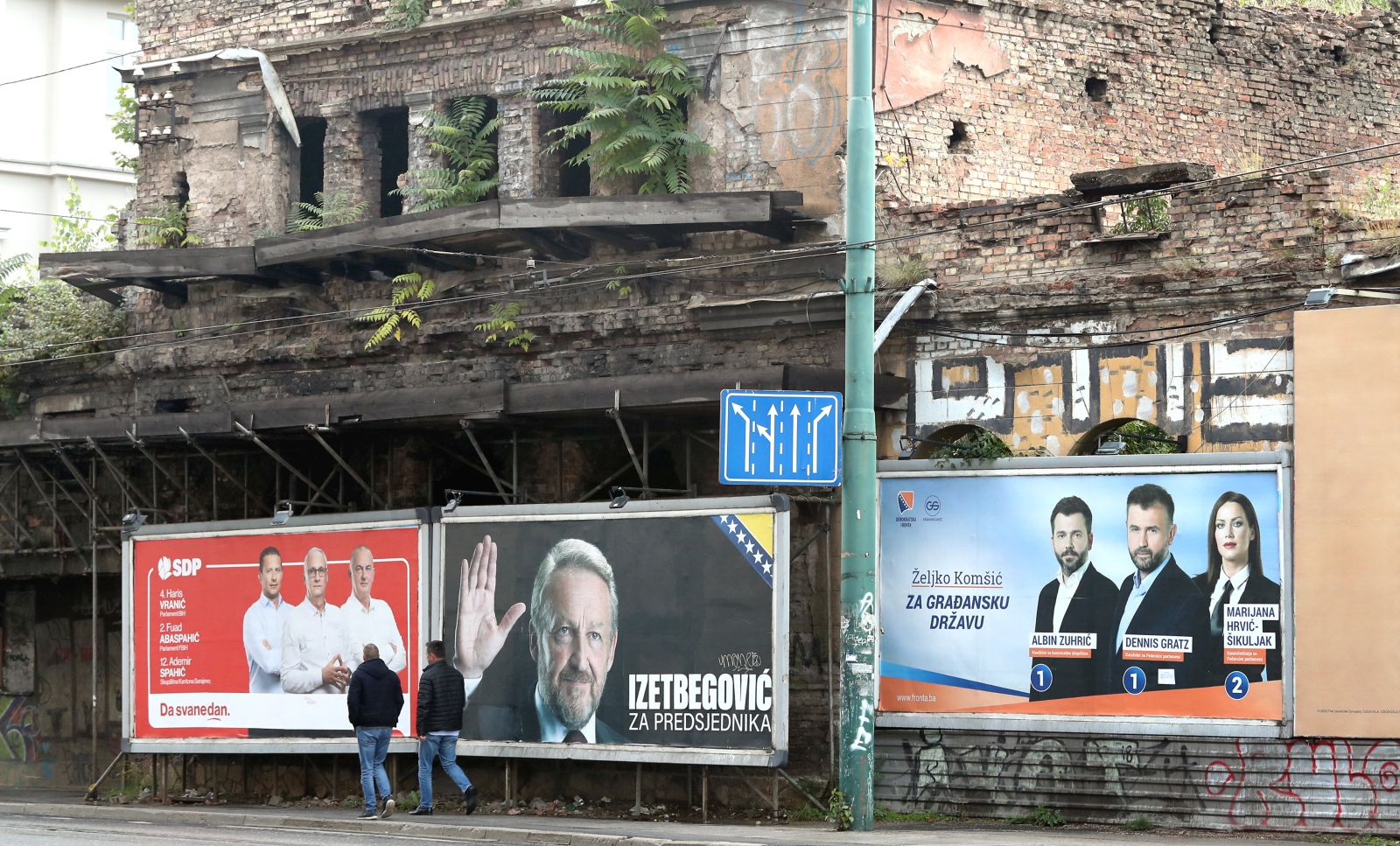 epa10211479 People walk past election campaign posters in Sarajevo, Bosnia and Herzegovina, 28 September 2022. More than three million Bosnian citizens are expected to vote in the country's general elections on 02 October. 90 political parties and 10 candidates for the three members of the Bosnian presidency were registered.  EPA/FEHIM DEMIR