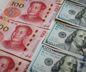 epa10212734 An illustration shows the 100 Chinese yuan or Renminbi (RMB) and 100 US dollar bills in Beijing, China, 29 September 2022. China's yuan hit a record low against US dollar on 28 September, the weakest since the global financial crisis in 2008, despite the central bank taking steps to rein in the currency's weakness.  EPA/MARK R. CRISTINO