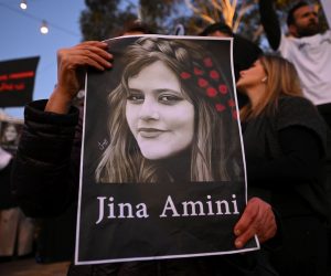epaselect epa10213316 A protester holds a placard picturing Masha Amini during a demonstration following the death of Mahsa Amini in Iran, at Federation Square in Melbourne, Victoria, Australia, 29 September 2022. Protests have continued to rage in Iran over the death in custody of Mahsa Amini, with demonstrators calling for the end of clerical rule.  EPA/JAMES ROSS AUSTRALIA AND NEW ZEALAND OUT