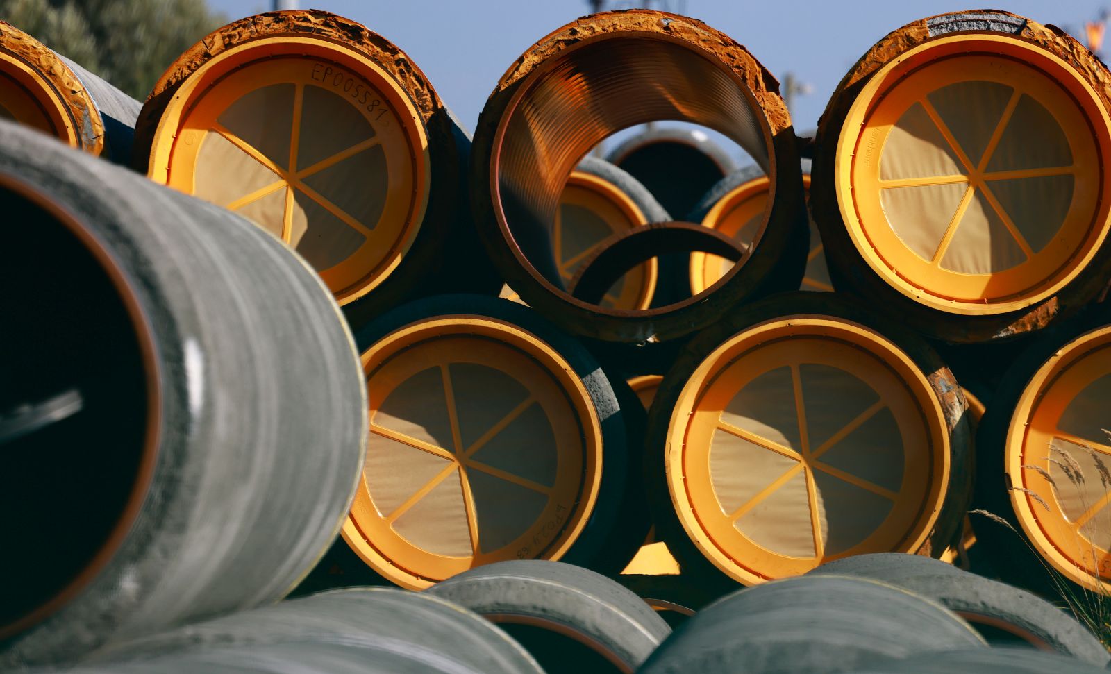 epa10215468 Unused pipes for the Nord Stream 2 Baltic gas pipeline are stored on the site of the Port in Mukran, Germany, 30 September 2022. The Swedish Coast Guard announced on 29 September that it discovered a fourth gas leak on the Nord Stream pipelines damaged earlier this week in the Baltic Sea.  EPA/HANNIBAL HANSCHKE