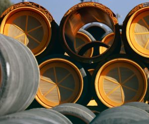 epa10215468 Unused pipes for the Nord Stream 2 Baltic gas pipeline are stored on the site of the Port in Mukran, Germany, 30 September 2022. The Swedish Coast Guard announced on 29 September that it discovered a fourth gas leak on the Nord Stream pipelines damaged earlier this week in the Baltic Sea.  EPA/HANNIBAL HANSCHKE