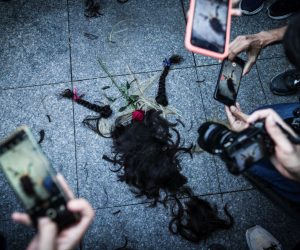 epa10219887 People take photos of a pile of hair cut by Iranian women during a protest following the death of Iranian Mahsa Amini, in Istanbul, Turkey, 02 October 2022. Amini, a 22-year-old Iranian woman, was arrested in Tehran on 13 September by the police unit responsible for enforcing Iran's strict dress code for women. She fell into a coma while in police custody and was declared dead on 16 September.  EPA/SEDAT SUNA