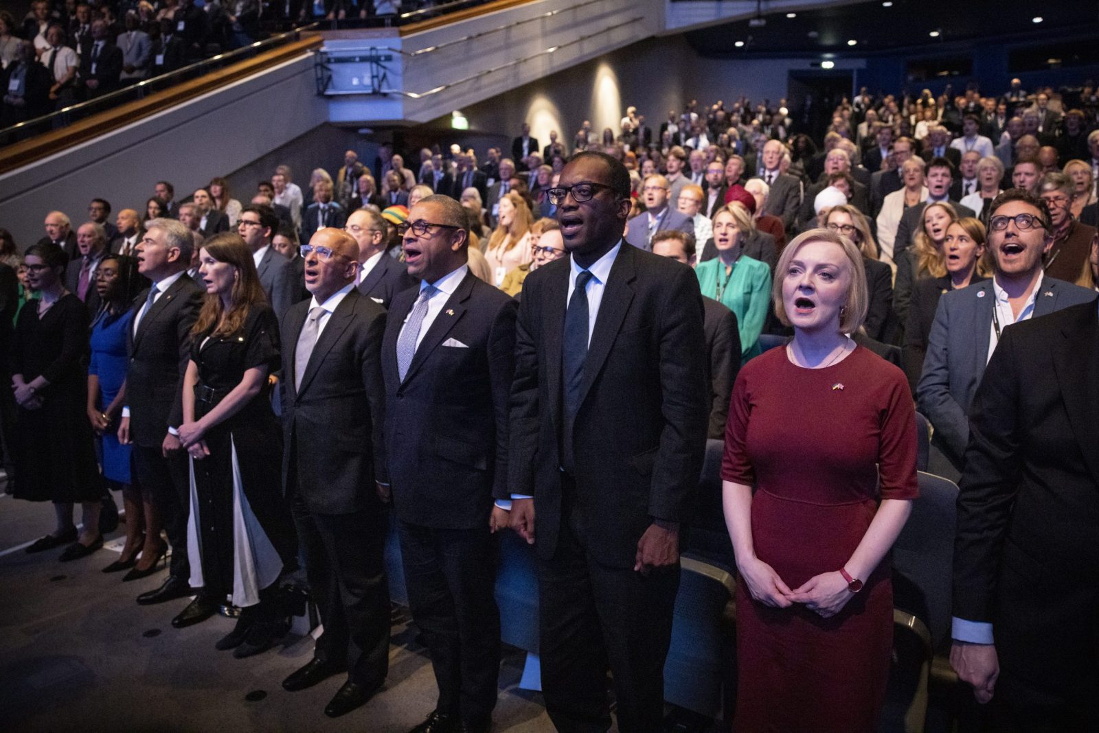 epa10219860 British Prime Minister Liz Truss and members of her cabinet sing the national anthem at the opening session of Conservative Party Conference in Birmingham, Britain, 02 October 2022. Prime Minister Liz Truss admitted they were flaws with the announcement of her 'mini-budget' which led to market turmoils and British pound going historic low against the US dollar.  EPA/TOLGA AKMEN