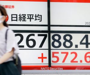 epa10222447 A pedestrian walks past a stock market indicator board in Tokyo, Japan, 04 October 2022. The Nikkei 225 Stock Average soared following optimism after the British government said that it will modify its criticized tax cut policy.  EPA/JIJI PRESS JAPAN OUT EDITORIAL USE ONLY/
