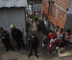 epa10223126 Police stand guard in the area where violence took place in the Brisas de Mayo neighborhood, in Cali, Colombia, 04 October 2022. At least five people were killed and two injured when armed men attacked a group of people who were on a corner of the Siloe neighborhood.  EPA/ERNESTO GUZMAN JR