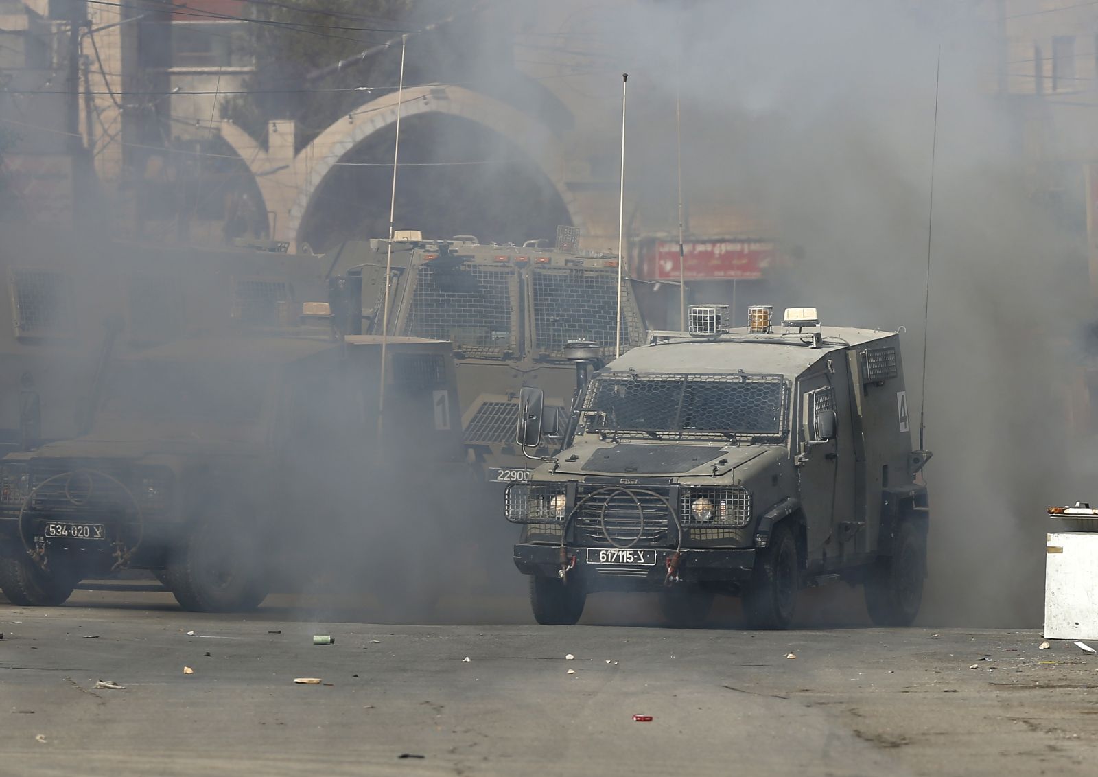 epa10230133 Israeli armored vehicles during Israeli Army operation at Jenin refugee camp, near the West Bank city of Jenin, 08 October 2022. According to the Palestinian Health Ministry, two Palestinians were killed and more than 10 others wounded during clashes after Israeli troops raided the Jenin refugee camp on 08 october morning.  EPA/ALAA BADARNEH