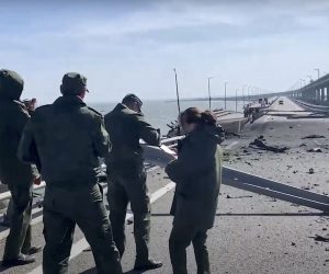 epa10230384 A still image taken from handout video provided by the Russian Investigative committee shows Russian investigators work on a collapsed part of the Kerch Strait bridge in Crimea, 08 October 2022. According to Russian authorities, "an explosion was set off at a cargo vehicle on the motorway part of the Crimean bridge on the side of the Taman peninsula, which set fire to seven fuel tanks of a train that was en route to the Crimean peninsula. Two motorway sections of the bridge partially collapsed."  EPA/RUSSIAN INVESTIGATIVE COMMITEE HANDOUT  HANDOUT EDITORIAL USE ONLY/NO SALES
